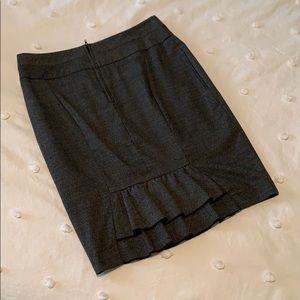 Gray pencil skirt with ruffle bottom on back.